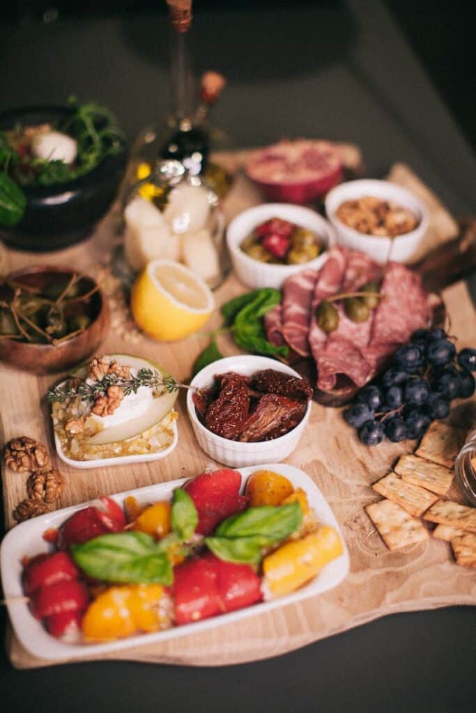 A beautifully arranged charcuterie board featuring meats, cheeses, fruits, and nuts perfect for a casual or romantic dinner.