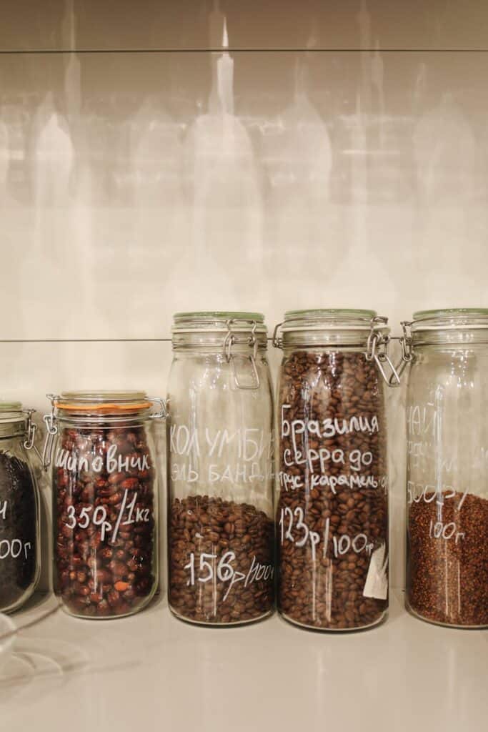 Neatly arranged glass jars filled with spices and coffee beans, promoting zero waste storage.