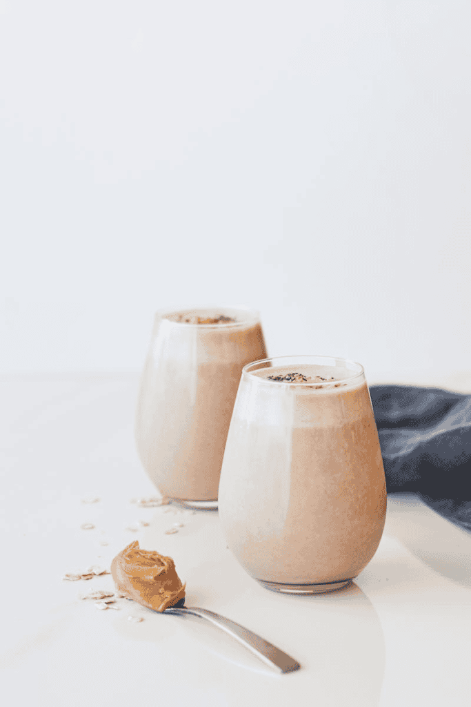 Delicious peanut butter chocolate smoothies with oats in glass tumblers.